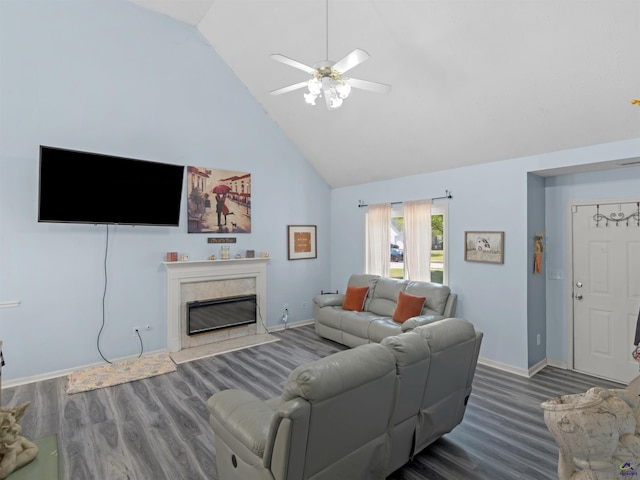 living area featuring wood finished floors, a high end fireplace, baseboards, high vaulted ceiling, and a ceiling fan