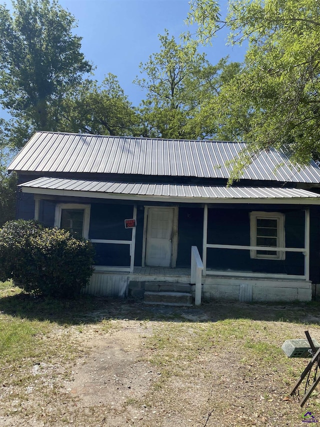 view of front of house with covered porch and metal roof