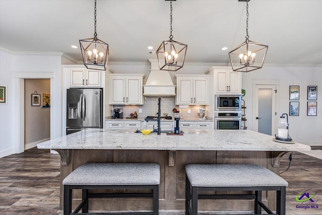 315 Apalachee Way, Bonaire, GA 31005 - kitchen with custom range hood, appliances with stainless steel finishes, white cabinets, baseboards, and a notable chandelier