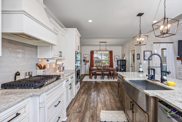 315 Apalachee Way, Bonaire, GA 31005 - kitchen with a sink, decorative backsplash, stainless steel appliances, a chandelier, and custom range hood