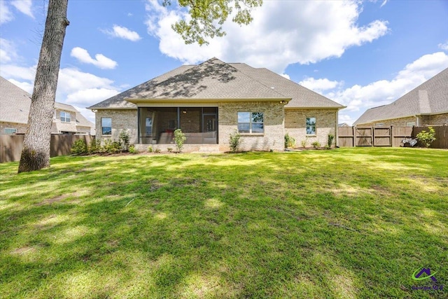 315 Apalachee Way, Bonaire, GA 31005 - rear view of house with brick siding, a fenced backyard, a yard, and a sunroom