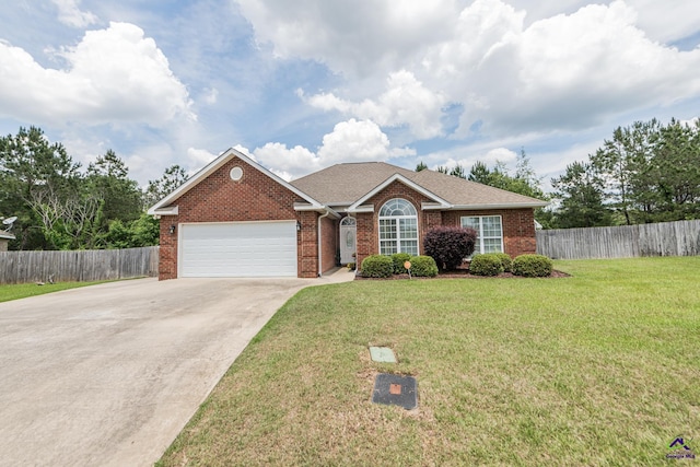 105 Taconic Ct, Bonaire, GA 31005 - ranch-style house with a front lawn, a garage, driveway, brick siding, and fence