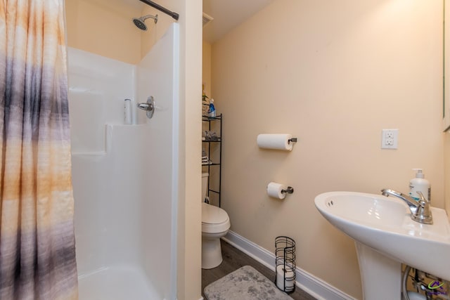 105 Taconic Ct, Bonaire, GA 31005 - full bath featuring toilet, a stall shower, wood finished floors, and baseboards