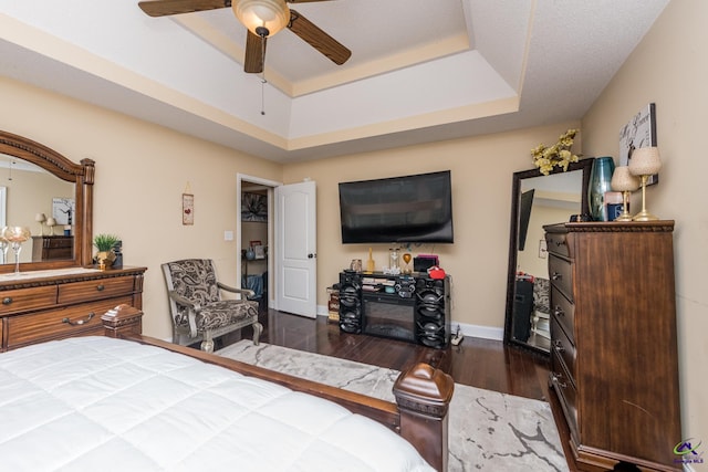 105 Taconic Ct, Bonaire, GA 31005 - bedroom featuring ceiling fan, baseboards, wood finished floors, and a tray ceiling