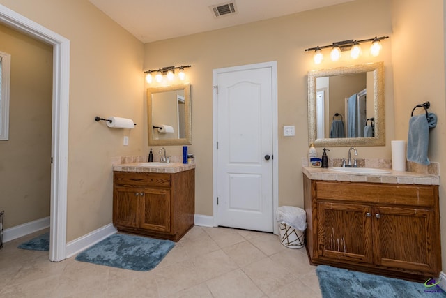 105 Taconic Ct, Bonaire, GA 31005 - bathroom featuring visible vents, two vanities, and a sink