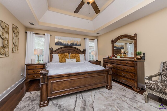 105 Taconic Ct, Bonaire, GA 31005 - bedroom with wood finished floors, baseboards, visible vents, a raised ceiling, and a ceiling fan