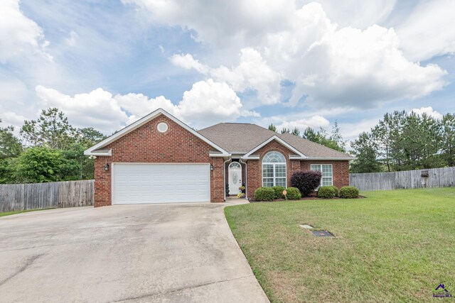 105 Taconic Ct, Bonaire, GA 31005 - ranch-style house featuring brick siding, fence, driveway, a front lawn, and an attached garage