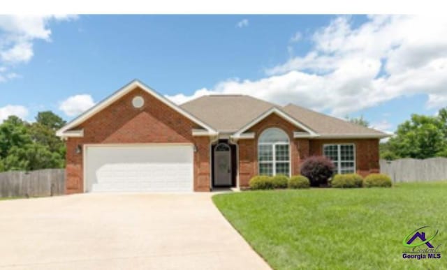105 Taconic Ct, Bonaire, GA 31005 - single story home with fence, a front lawn, concrete driveway, and an attached garage