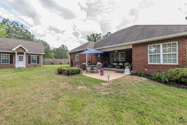 105 Taconic Ct, Bonaire, GA 31005 - rear view of house featuring fence, a lawn, a patio area, and brick siding