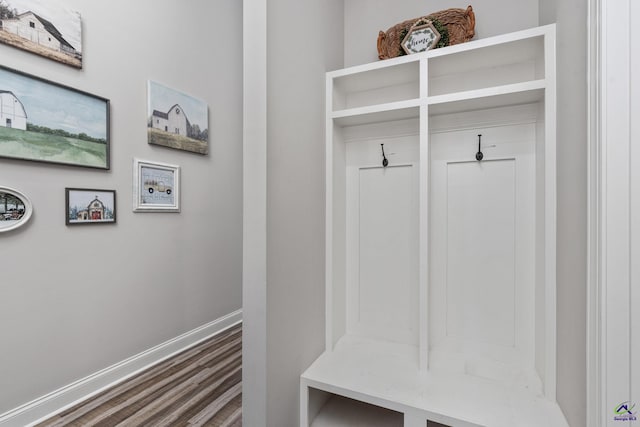 mudroom featuring baseboards and wood finished floors