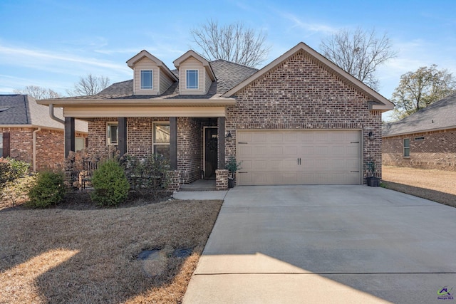 view of front of property with covered porch, brick siding, a garage, roof with shingles, and concrete driveway