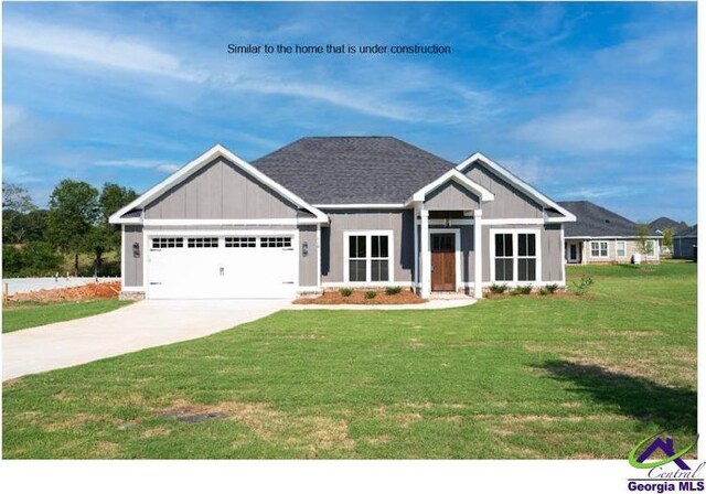 craftsman-style home with board and batten siding, an attached garage, concrete driveway, and a front yard