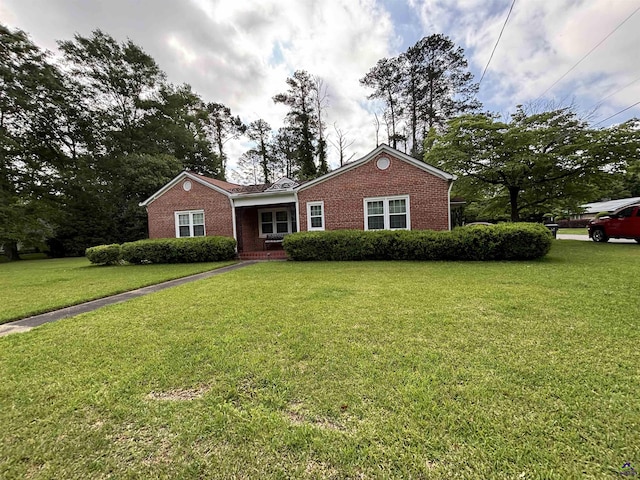 ranch-style home with brick siding and a front lawn