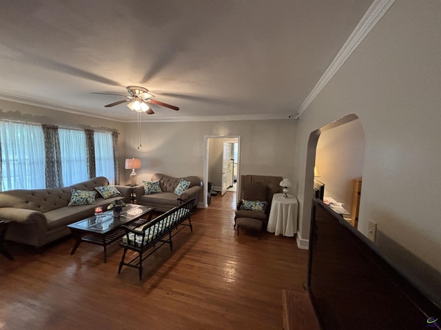 living room featuring arched walkways, ceiling fan, ornamental molding, and dark wood-style flooring