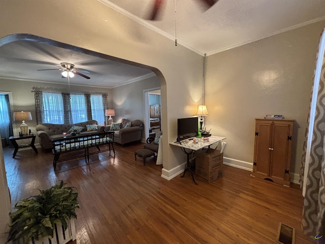 interior space featuring ceiling fan, visible vents, arched walkways, ornamental molding, and dark wood-type flooring