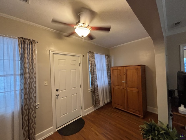 foyer entrance featuring crown molding, dark wood-style flooring, ceiling fan, and baseboards