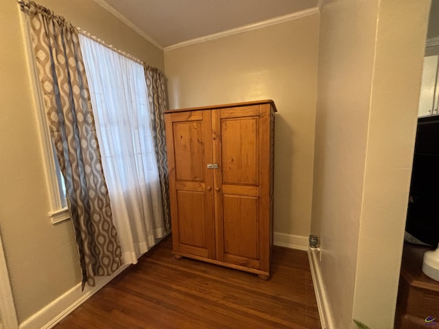 interior space with crown molding, baseboards, and wood finished floors