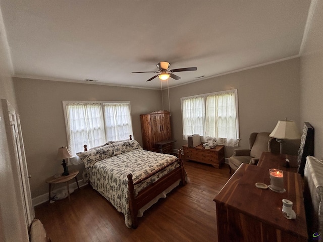 bedroom featuring crown molding, dark wood finished floors, and visible vents