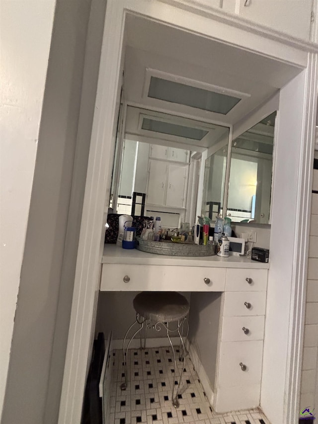 bathroom with tile patterned floors and vanity