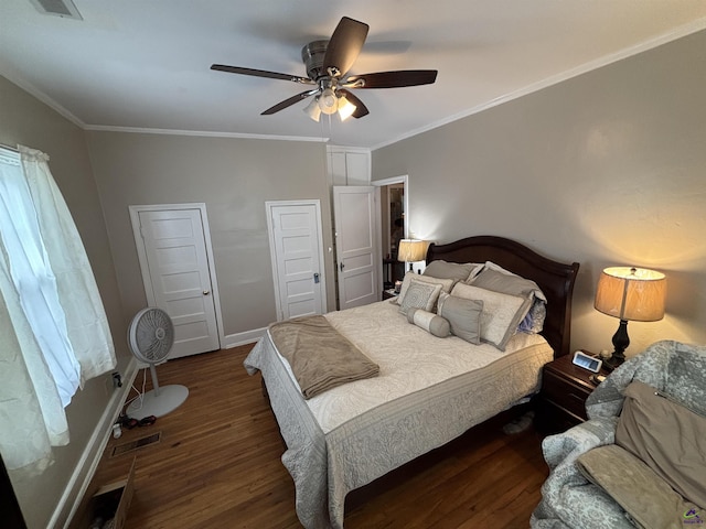 bedroom featuring crown molding, visible vents, wood finished floors, baseboards, and ceiling fan