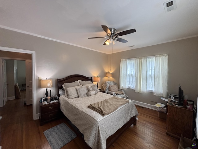 bedroom with baseboards, wood finished floors, and visible vents
