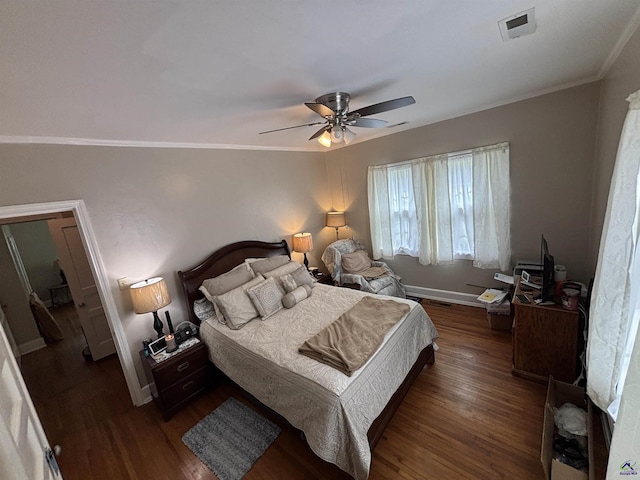bedroom with visible vents, ornamental molding, dark wood-style flooring, and ceiling fan