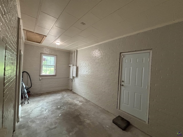 interior space with concrete floors and brick wall