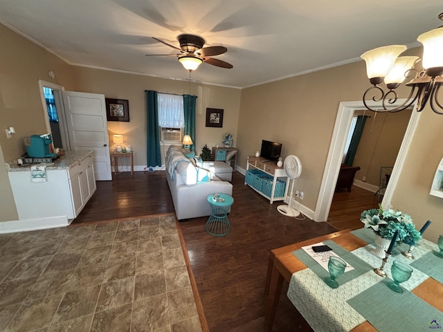 living room with crown molding, baseboards, wood finished floors, and ceiling fan with notable chandelier