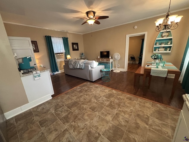 living area with crown molding, baseboards, ceiling fan with notable chandelier, and dark wood finished floors