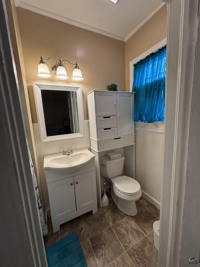 bathroom featuring crown molding, toilet, and vanity