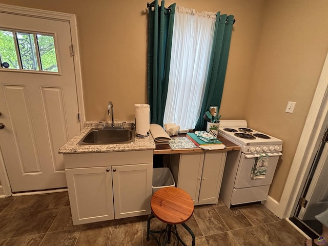 interior space with a sink and baseboards