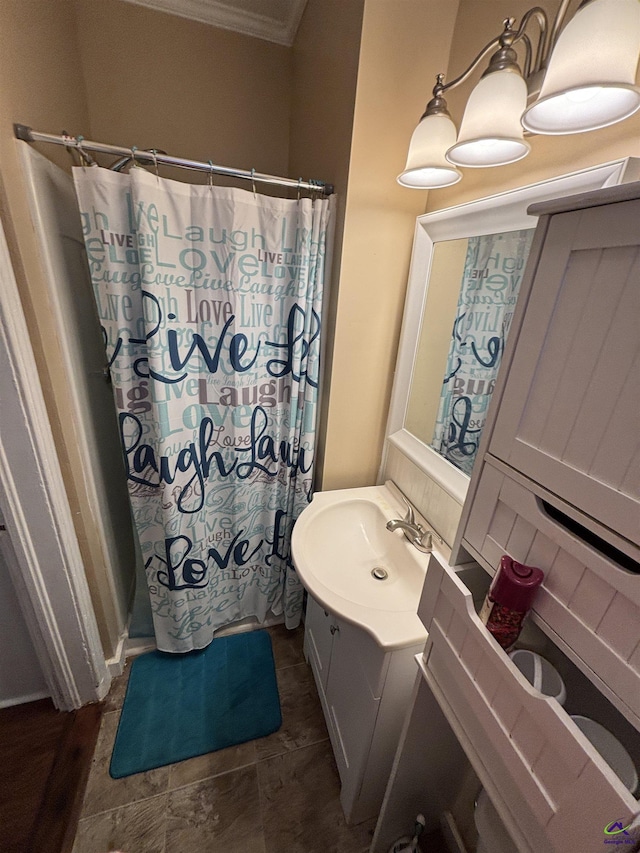 bathroom featuring vanity, ornamental molding, and a shower with curtain