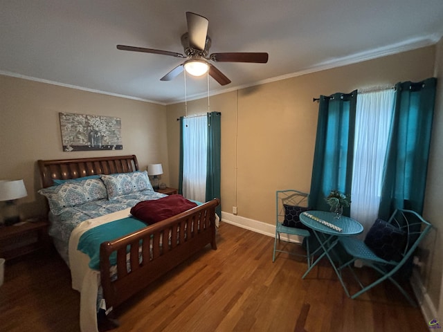 bedroom featuring crown molding, baseboards, ceiling fan, and wood finished floors
