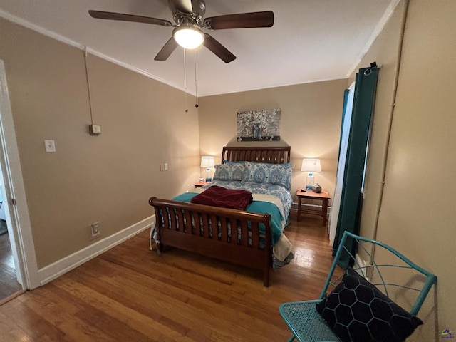 bedroom featuring baseboards, ornamental molding, a ceiling fan, and wood finished floors