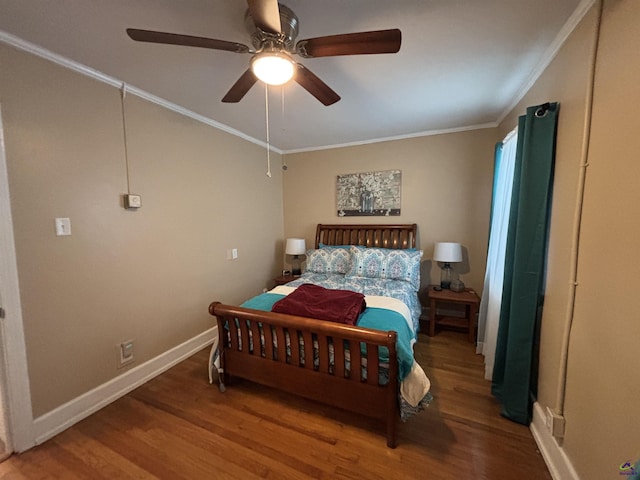 bedroom with baseboards, ornamental molding, ceiling fan, and wood finished floors
