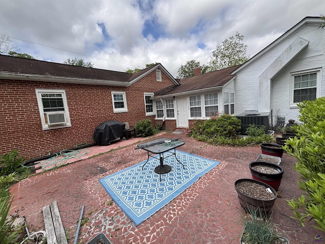 view of patio featuring cooling unit and area for grilling