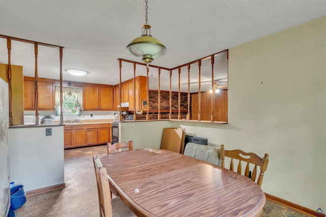 dining area with baseboards and a textured ceiling