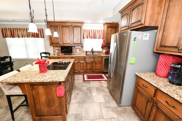 kitchen with plenty of natural light, a sink, a breakfast bar area, and stainless steel appliances