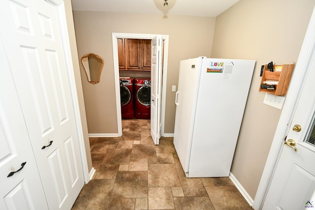 hallway featuring stone finish floor, baseboards, and separate washer and dryer