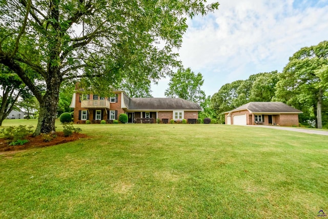 tri-level home featuring an attached garage, driveway, brick siding, and a front yard