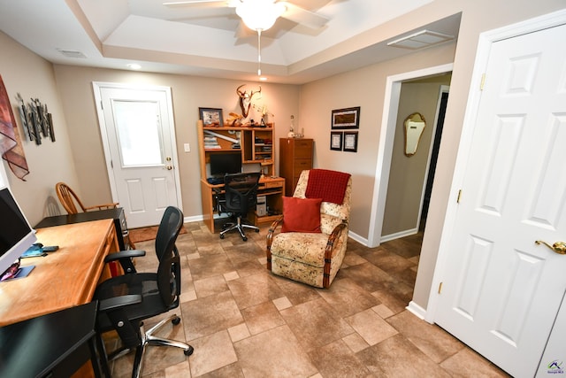 home office featuring baseboards, a ceiling fan, a raised ceiling, and visible vents
