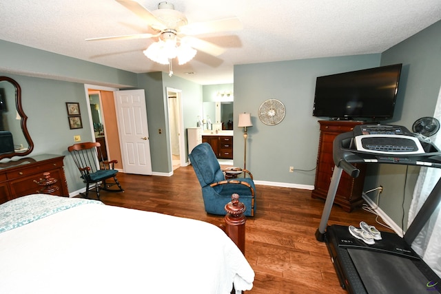 bedroom with baseboards, ensuite bathroom, a ceiling fan, and wood finished floors