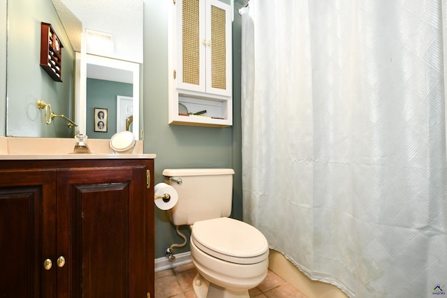 bathroom with vanity, toilet, baseboards, a shower with shower curtain, and tile patterned floors