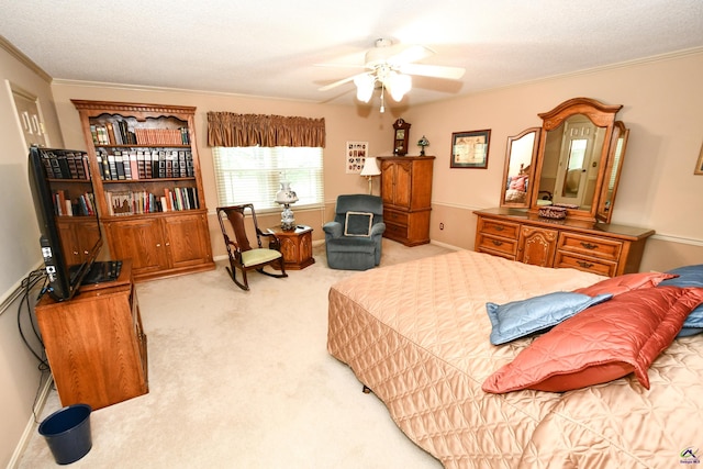 bedroom with crown molding, baseboards, a ceiling fan, and light colored carpet