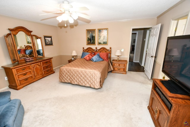 bedroom featuring a ceiling fan, light carpet, and ornamental molding