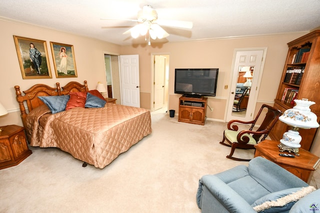 bedroom with crown molding, ceiling fan, and light colored carpet