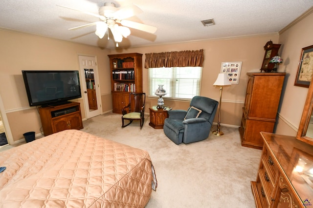 bedroom featuring visible vents, a textured ceiling, crown molding, and light colored carpet