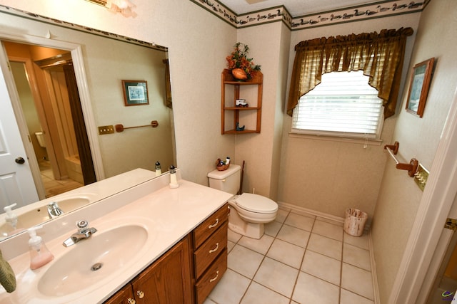 bathroom featuring vanity, tile patterned floors, and toilet