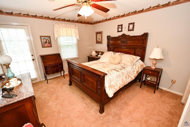 bedroom featuring a ceiling fan, baseboards, light carpet, and access to exterior