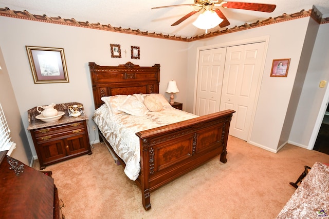 bedroom with a closet, a ceiling fan, baseboards, and light colored carpet